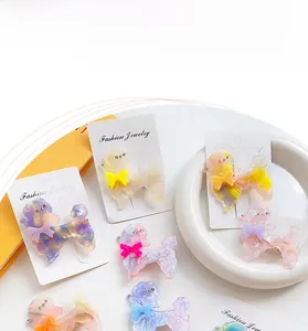 Detail of poodle hair clips with marble texture, bows, and metal duckbill clips