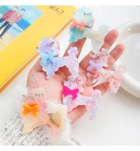 Detail of colorful acetate poodle hair clips with sparkling rhinestones and bows