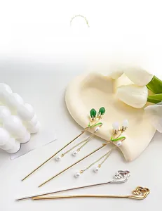 Detailed shot of Chinese tulip hair sticks and hollow cloud pins with pearl tassels