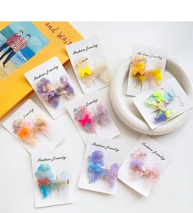 Detailed set of 8 acetate poodle hair clips featuring marble texture and rhinestones