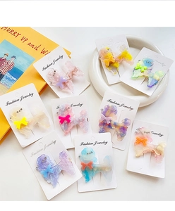 Detailed macro view of acetate puppy hair clips with rhinestones and marble patterns