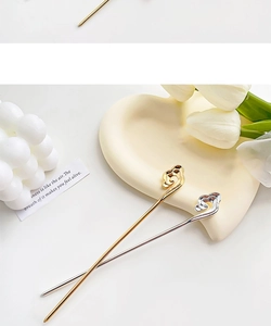 Detailed close-up of Ruyi cloud pattern metal hairpins in gold and silver plating