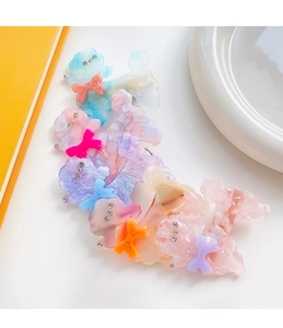 Macro view of acetate poodle hair clips with sparkling rhinestones in pastel colors