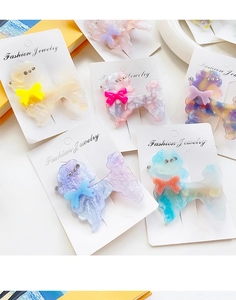 Close-up of acetate poodle hair clips with sparkling rhinestones and colorful bows