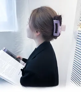 Detail of a large purple marble acrylic hair claw clip securing a elegant updo hairstyle