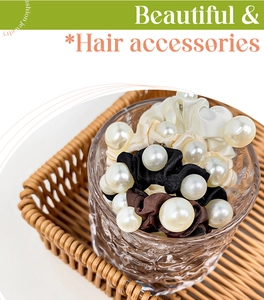 Detail of satin scrunchies with large faux pearls in black, brown and creamy white