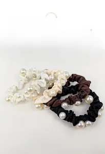 Detailed set of three satin hair scrunchies with white pearls in cream and brown