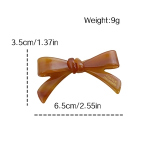 Handmade acetate bow hair clip with tortoiseshell pattern and dimensions for women