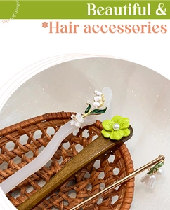 Detail of elegant Chinese hair sticks with lily of the valley and floral accents