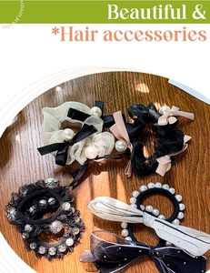 Detailed set of elegant pearl hair scrunchies and bow elastics on wooden surface