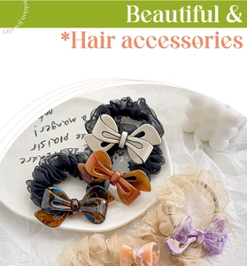 Chic acetate bow hair ties in amber and marble textures on lace scrunchie detail