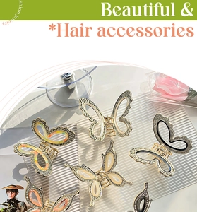Macro detail of elegant golden alloy butterfly hair claws with shimmering rhinestones