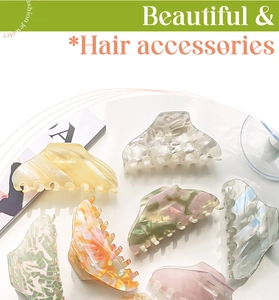 Flat lay of large hair claw clips in various acetate marble and aurora color patterns