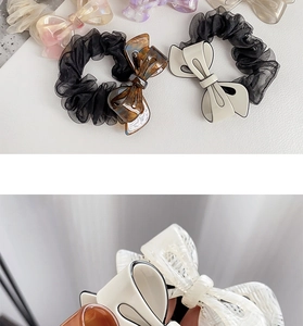 Detail of acetate tortoiseshell bow clips and black organza hair scrunchie set