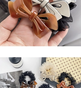 Detailed view of elegant acetate bow hair ties with delicate organza lace ruffles