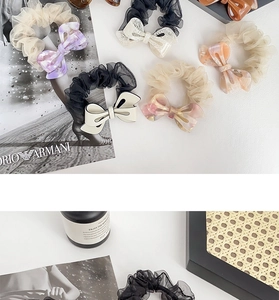 Close-up of bow organza scrunchies in assorted colors with marbled resin accents