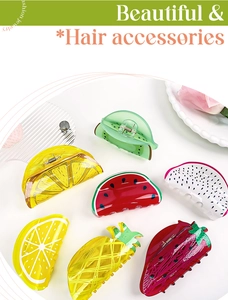 Flat lay of colorful acrylic fruit hair claws featuring lemon, watermelon and strawberry