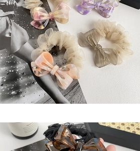 Detail of elegant organza hair scrunchies with marble pattern acetate bow accents