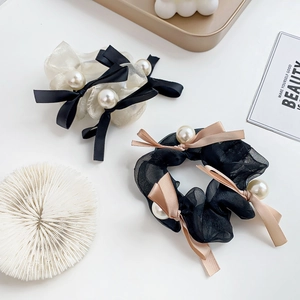 Elegant organza bow hair scrunchies with large pearls in classic black and white colors