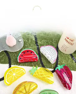 Close-up of colorful acrylic fruit hair claws including lemon, watermelon and pineapple