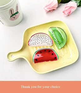 Detail of creative acrylic fruit hair claws featuring dragon fruit, kiwi, and watermelon designs