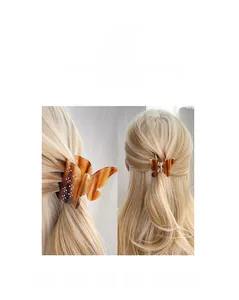 Macro shot of butterfly hair claw clip with amber texture resin and rhinestone inlay