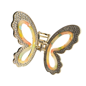 Golden butterfly hair claw clip with colorful marble wings and white rhinestones decoration