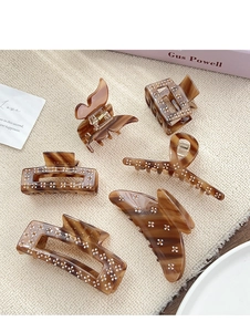 Detail of tortoise shell claw clips set featuring delicate floral rhinestone embellishments