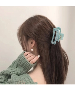 Détail d'une pince à cheveux en acétate bleu clair avec strass pour coiffure chic
