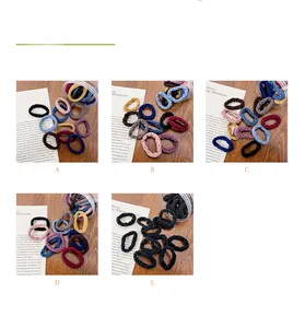 Detail of high-elasticity seamless hair ties in assorted colors with clear storage cans