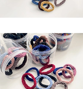 Multi-color seamless hair ties in a transparent storage jar with ribbed texture
