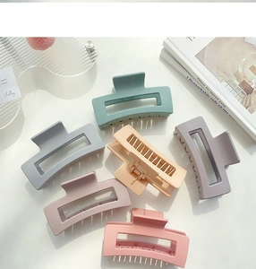 Close-up of rectangular matte hair claws in various Morandi colors with metal springs