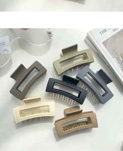 Macro detail of matte rectangle shark hair claws in various earthy morandi colors