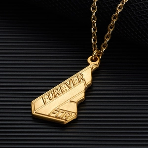 Macro detail of gold-tone geometric pendant with Forever For engraving and O-chain link