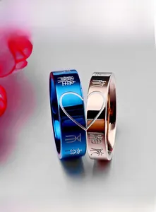 Detail view of steel couple rings with engraved Chinese script and heart pattern