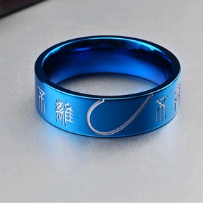 Macro shot of bright blue stainless steel ring featuring vintage etched seal script
