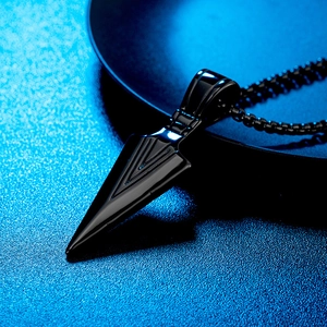 Macro shot of a black viking spearhead pendant with geometric grooves on a black bead chain