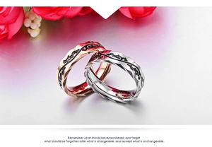 Detail of rose gold and silver vine pattern rings with faceted edges and polished finish