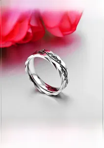 Detail shot of the etched retro vine texture and twisted edges on this polished ring