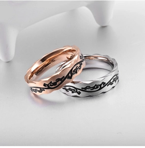 Macro detail of rose gold and silver rings with vine patterns and wavy edges
