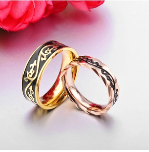 Faceted gold and rose gold vine pattern couple rings set with black enamel details
