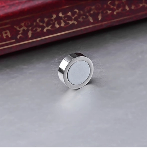 Macro shot of silver magnetic stud earring with a polished finish for non-pierced ears