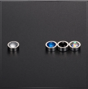 Macro view of four magnetic round crystal stud earrings in blue, clear, black, and AB colors