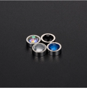 Detail showing four colors of magnetic stud earrings with multi-faceted crystal centers