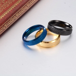 Detail of 6mm vacuum-plated gold, blue and black matte rings on satin with gift box