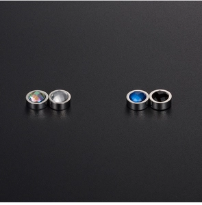 Close-up of magnetic stud earrings featuring colorful, white, blue, and black crystal stones
