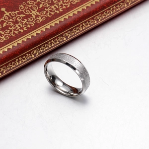 Titanium steel matte ring with polished edges and silver sand finish on textured background