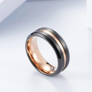 Detail of brushed black surface and rose gold lining on men's two-tone ring
