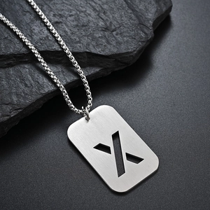 Close-up of matte brushed stainless steel necklace with hollow X alphabet pendant