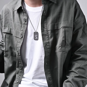 Men's stainless steel dog tag necklace with geometric cutout on long metal chain